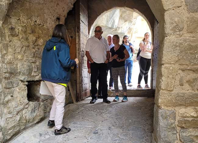 Els primers visitants, creuant la portalada fortificada d'accés. Autor: Diputació de Barcelona